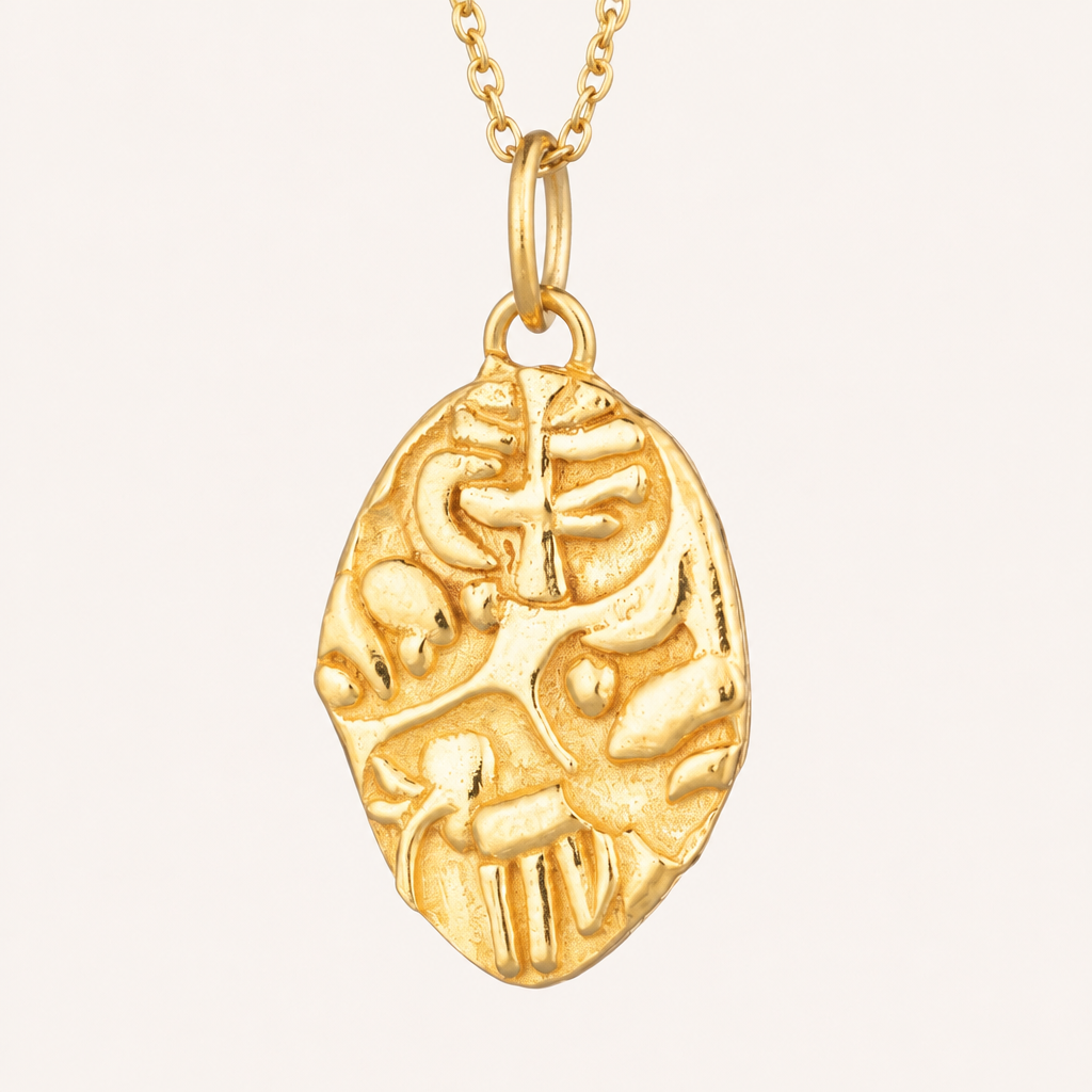 Close-up of the Sohavi Ancient Indian Coin Necklace’s oval gold-coloured pendant, showing raised motifs and the pendant bail.