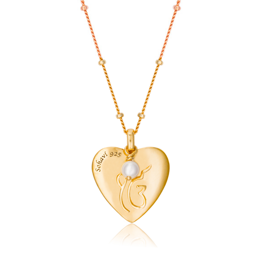 Ik OanKar meaning one divine creator is the symbol floating on a love heart with 3mm cultured freshwater pearl. Chain is adjustable can be worn at 16 or 18 inch length. Sterling silver with 18K Gold vermeil.