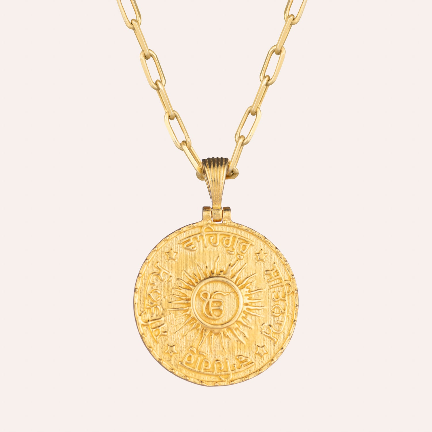 Reverse side of the Sohavi Guru Nanak coin necklace features the ancient mantra Satnam & Waheguru  in Gurmukhi script. Centred is the Ik Oankar symbol . Sterling silver with 22K gold Vermeil.